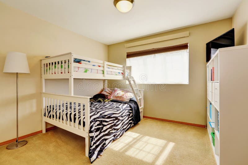 Sunny beige kids` room with bunk bed. Sunny beige kids` room with a bunk bed with built-in ladder and dressed in zebra print bedding. Northwest, USA stock image