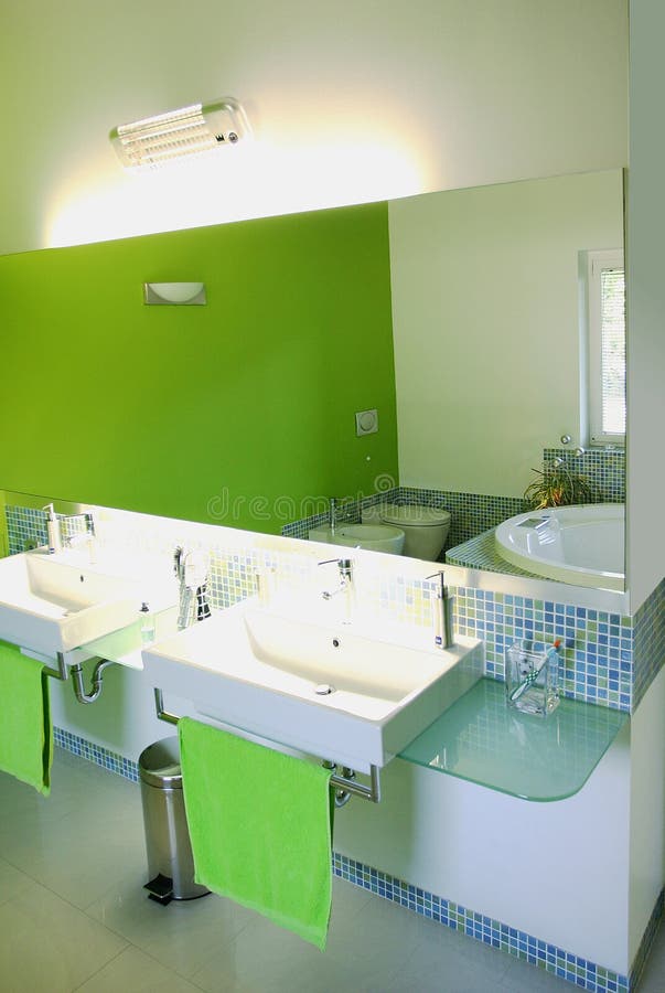 Vivid bathroom in a green mosaic. Modern home bathroom in a green color and mosaic tiles stock photos