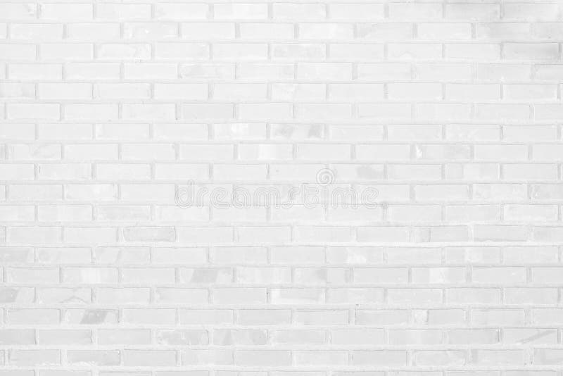 White brick wall texture background. Brickwork or stonework flooring interior rock old pattern clean concrete grid uneven bricks. Grey and white brick wall stock image