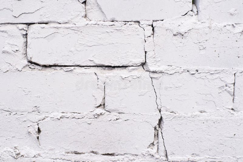 White coating. Old brickwork. Uneven surface. White small old brick royalty free stock photography