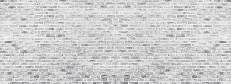 Wide white brick wall texture. Rough light gray brickwork. Whitewashed panoramic vintage background. Wide white washed brick wall texture. Rough light gray royalty free stock photo