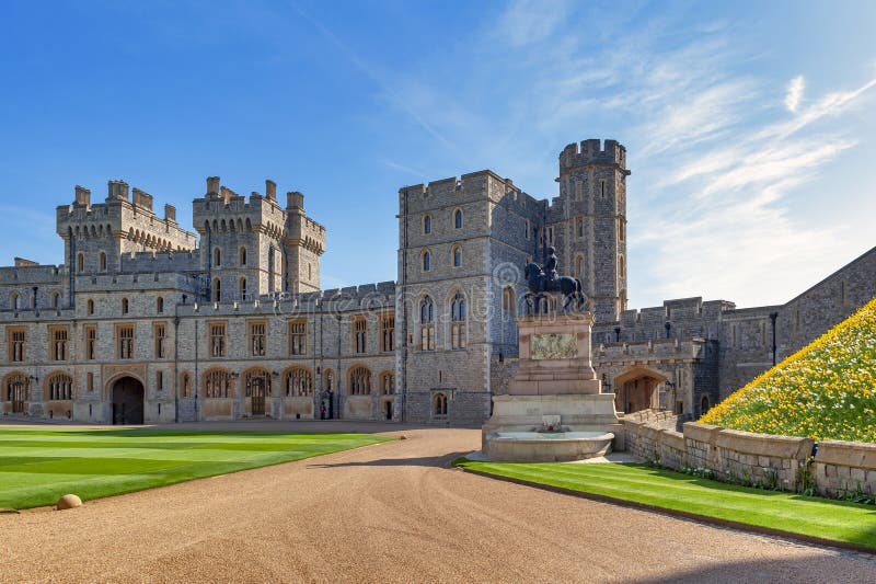 Group of buildings, King Charles II Statue at Windsor Castle, a royal residence at Windsor in county of Berkshire, England, UK. Windsor, UK - April 2018: Group stock photo